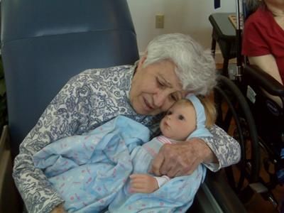 a senior getting attached to the baby under Nurturing Therapy Session