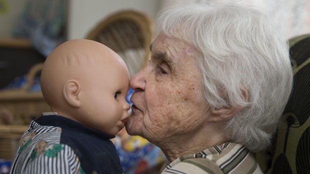 seniors holding a baby under the Nurturing Therapy
