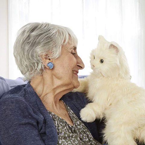 Woman with robotic cat for Animal-assisted therapy