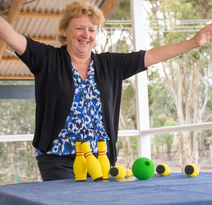 Senior in aged care playing Skittles