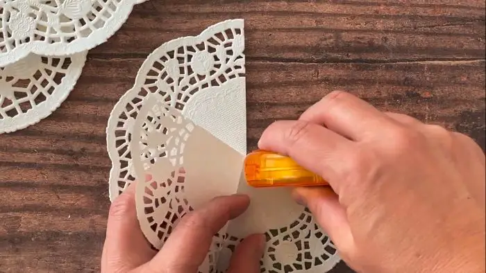 first step in making the Paper Doily Christmas Tree Craft
