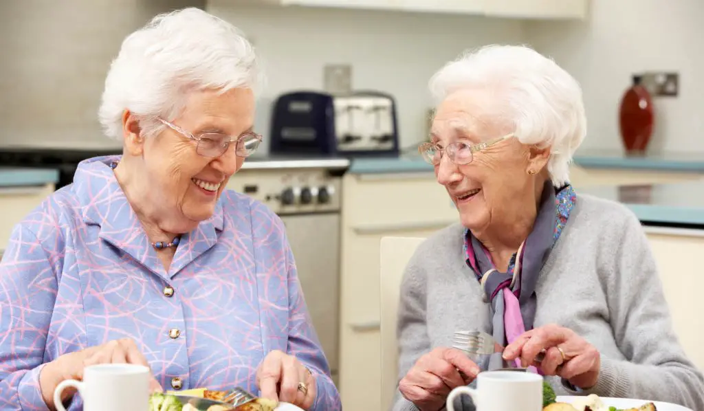 elderly women happily enjoying their Shrove Tuesday - Pancake Day activity