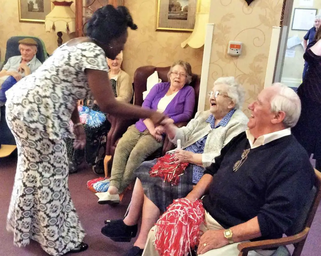 Aged care guests talking to elderly lady during international women's day