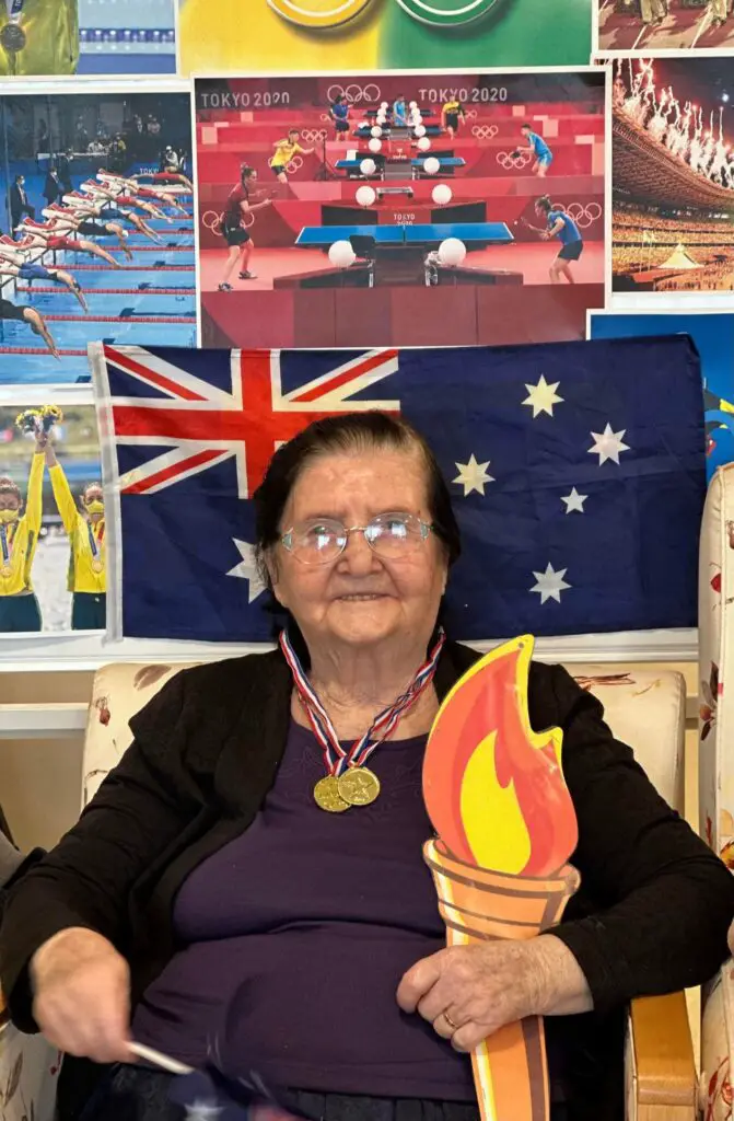 elderly woman with medals and a printable Olympic torch