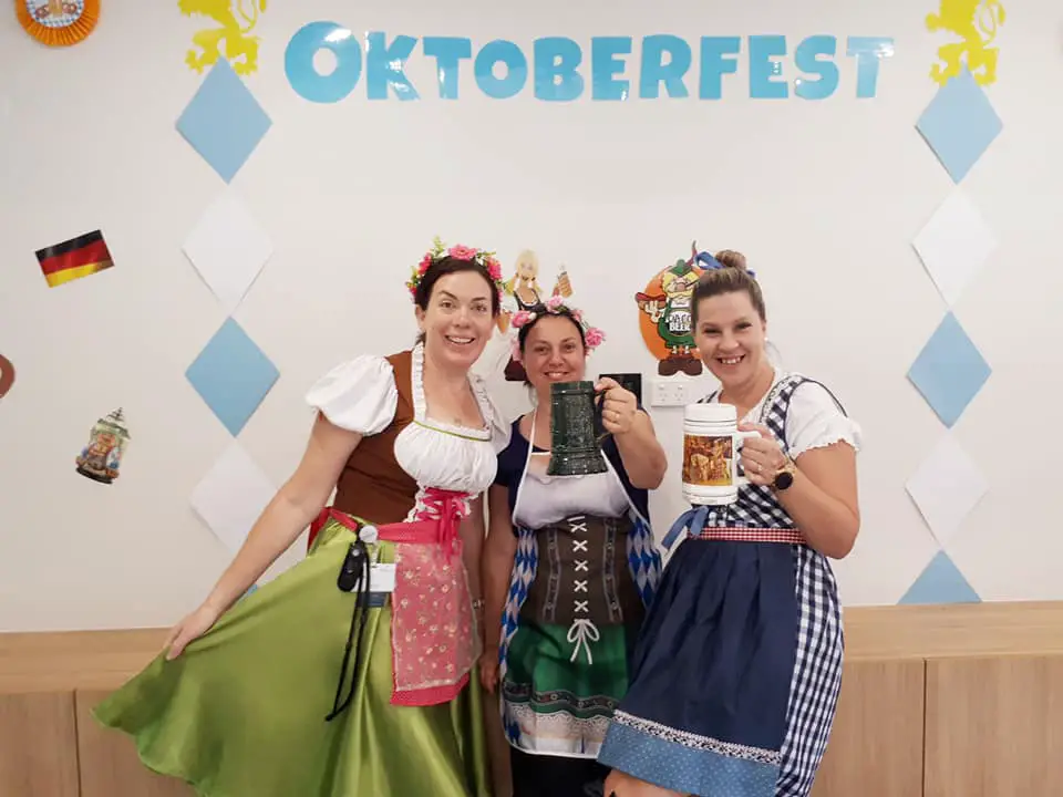 Women dressed in dresses covered in aprons for the Oktoberfest theme day