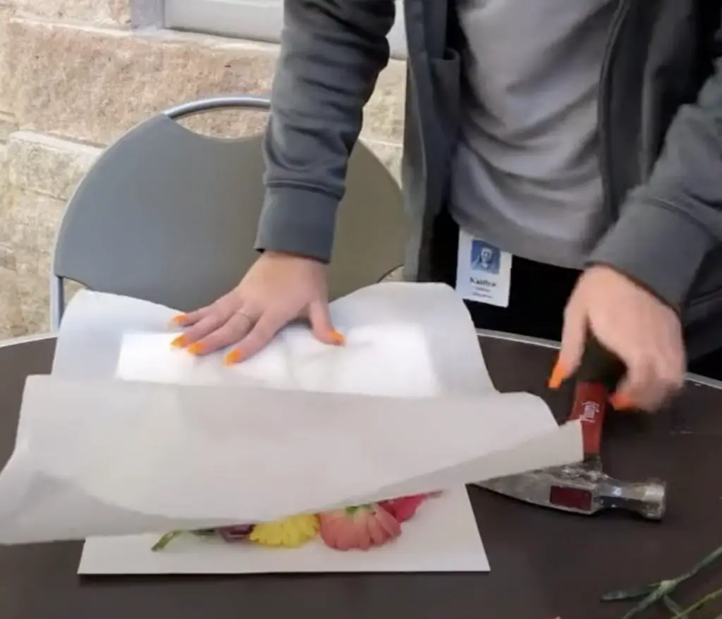 placing the wax paper on top of the arranged flowers