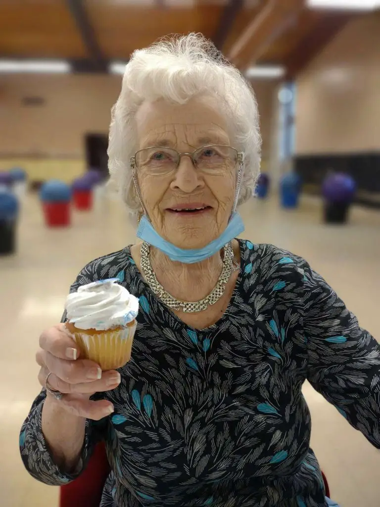 elderly woman with cupcake
