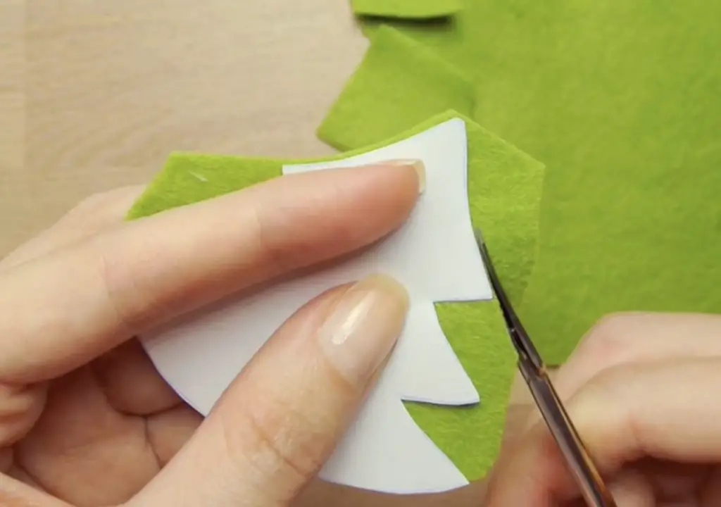 Tracing and cutting the cardboard into tree shapes