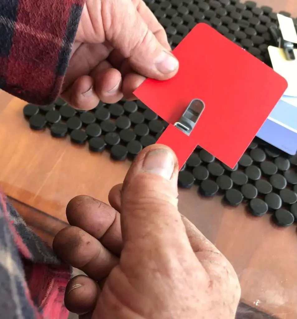 a red colored clothes peg is attached to the red card