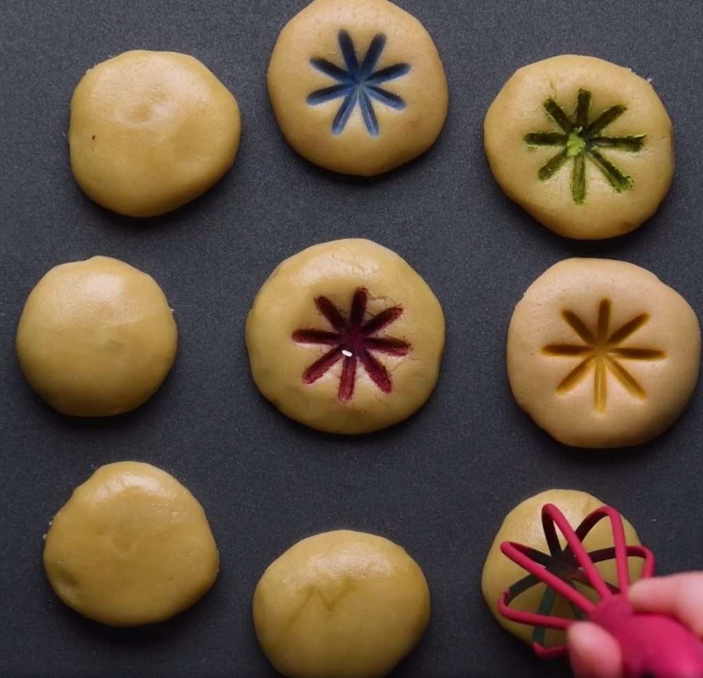 Cookie doughs are pressed with different colors for creative cookie baking