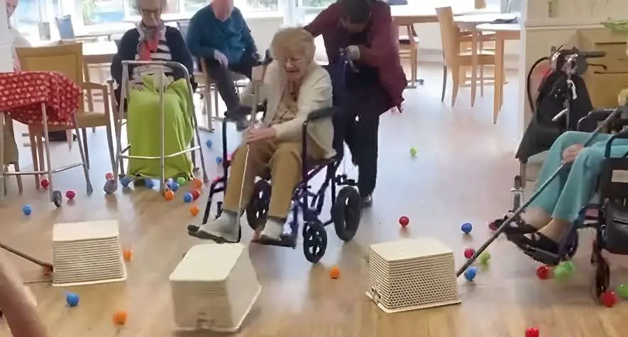 An elderly lady playing hungry hippos