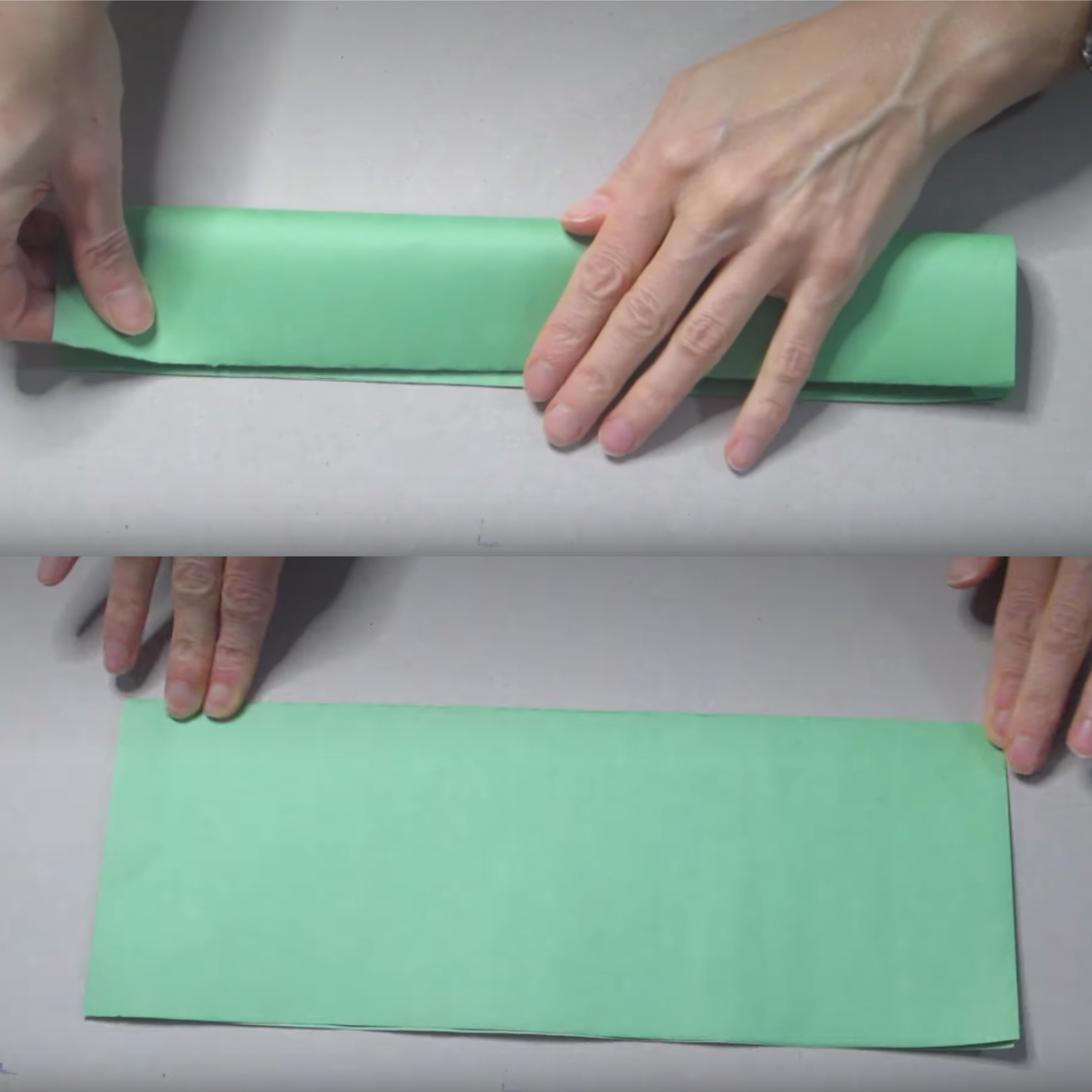 A person folding a crafting paper
