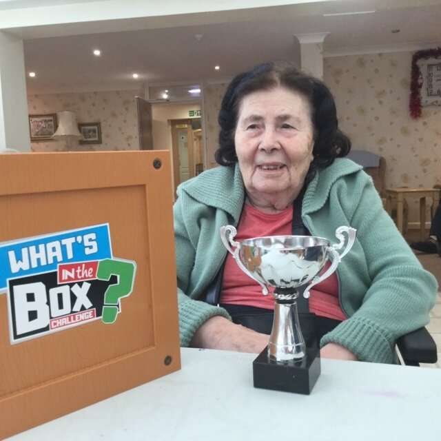 elderly woman playing what's in the box game