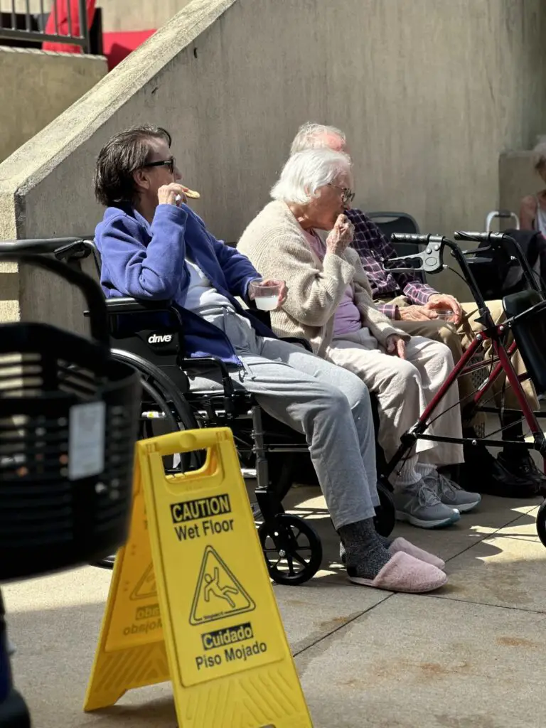 seniors in wheelchair eating snacks