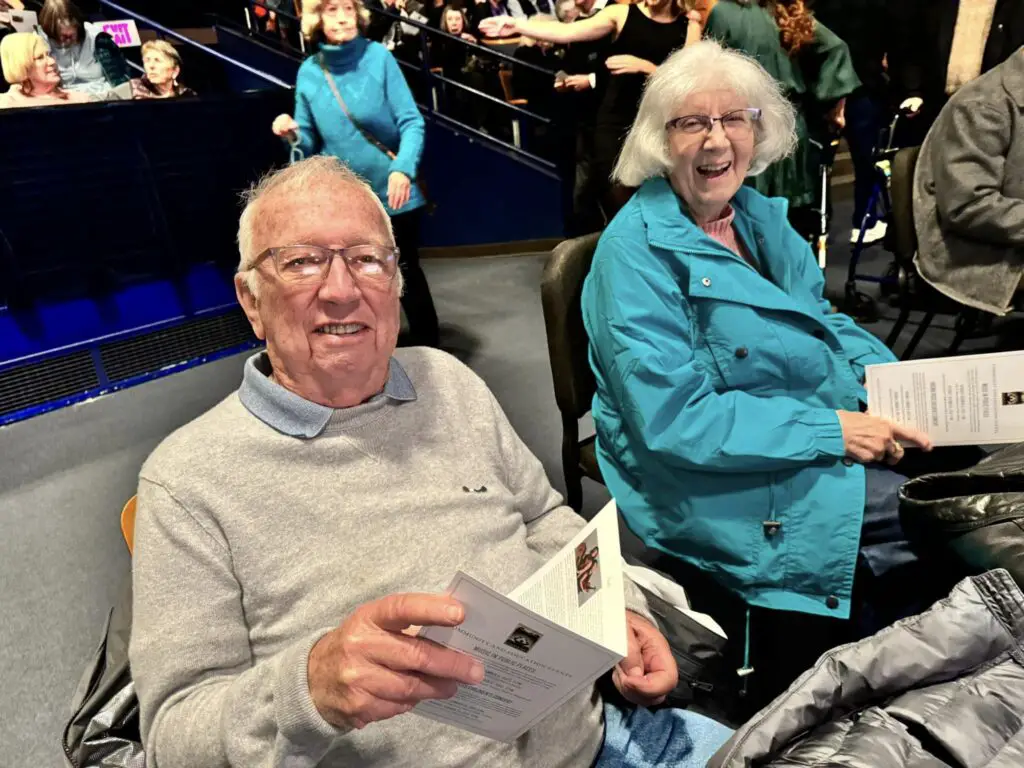 elderly man and woman reading brochure
