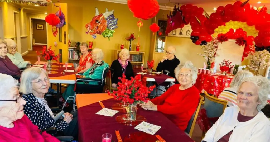 aged care seniors in a lunar new year themed gathering hall