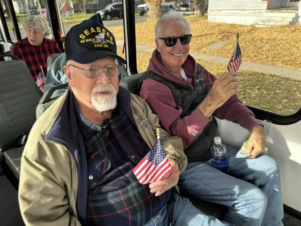 two elderly man with USA flag
