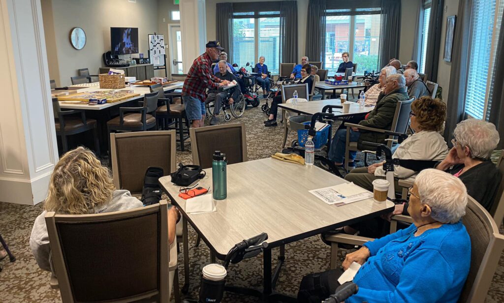 elderly man facilitating presidents' day quiz in aged care