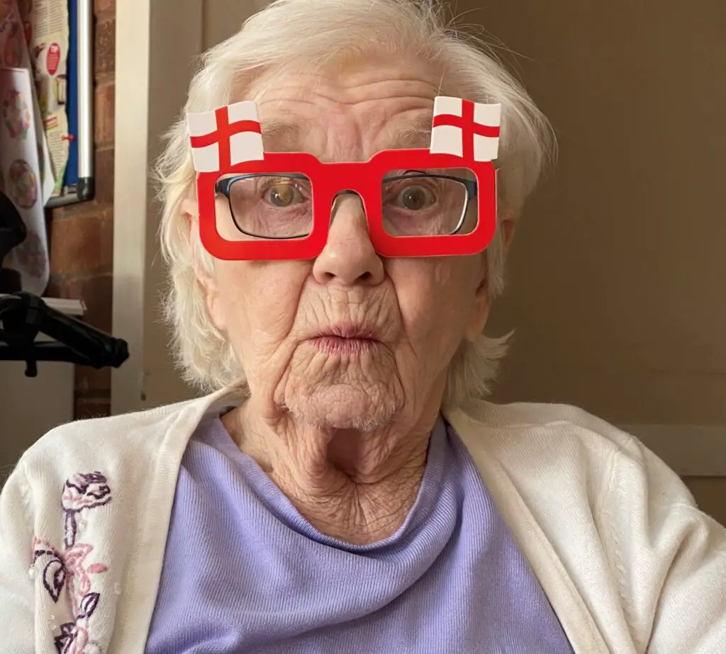 silly looking grandma with England Themed glasses