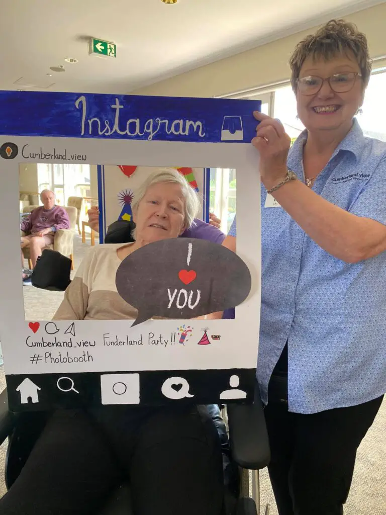 Senior and aged care staff in a Instagram-themed photo booth.