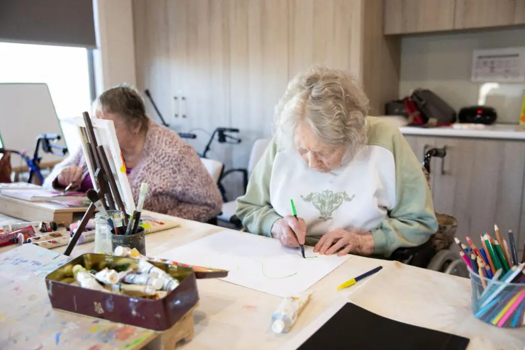Elderly woman making School days reminiscing cards