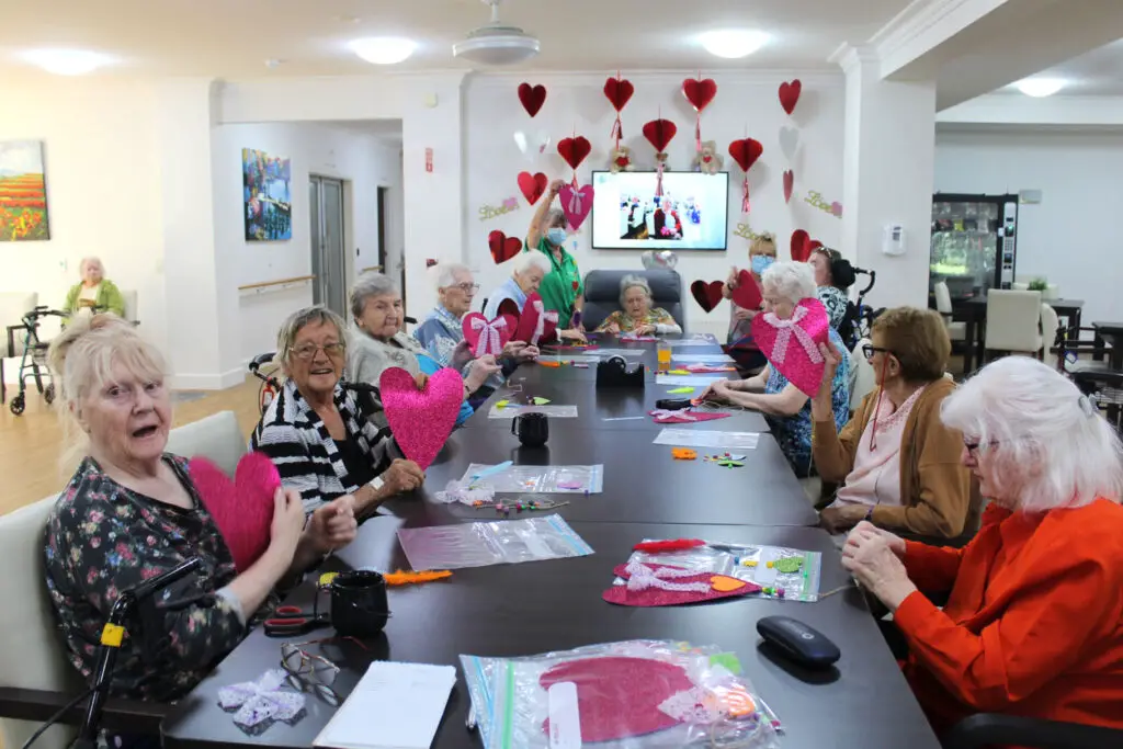 Elderly people crating crafts for the Valentine's day activity