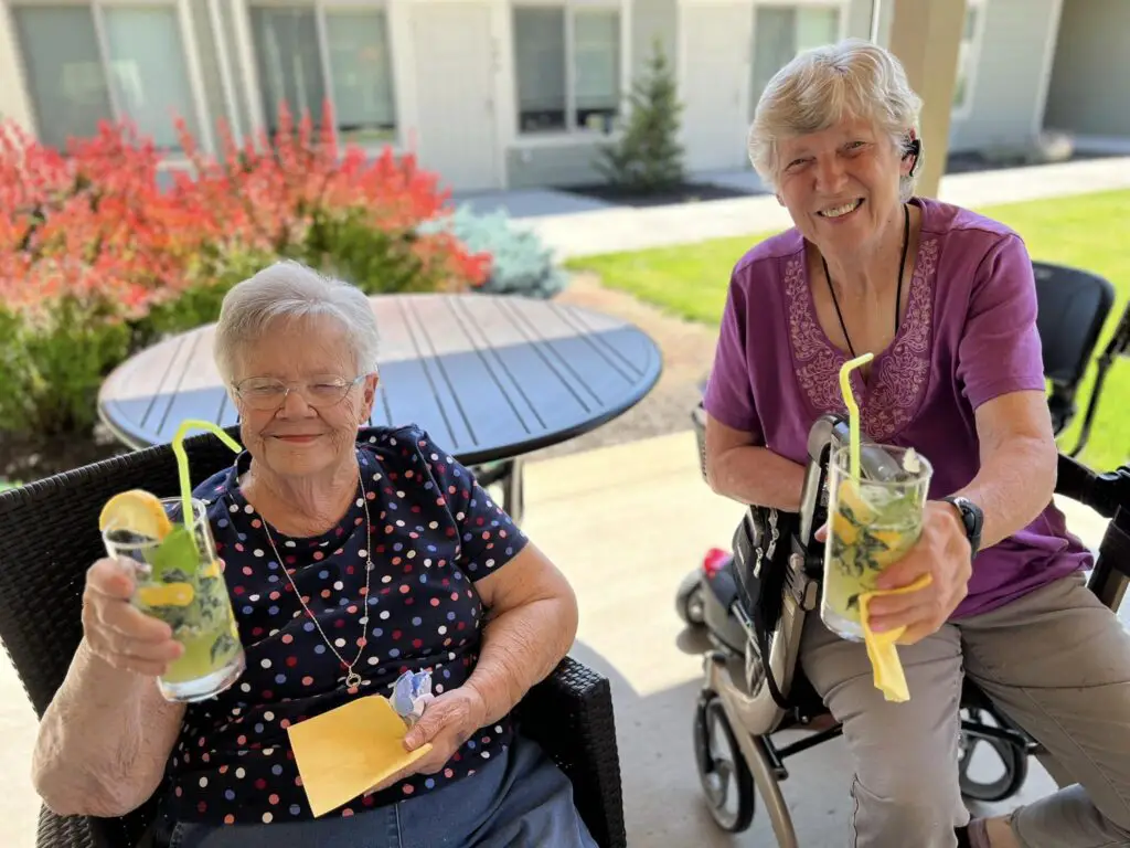 two elderly ladies drinking lemonade