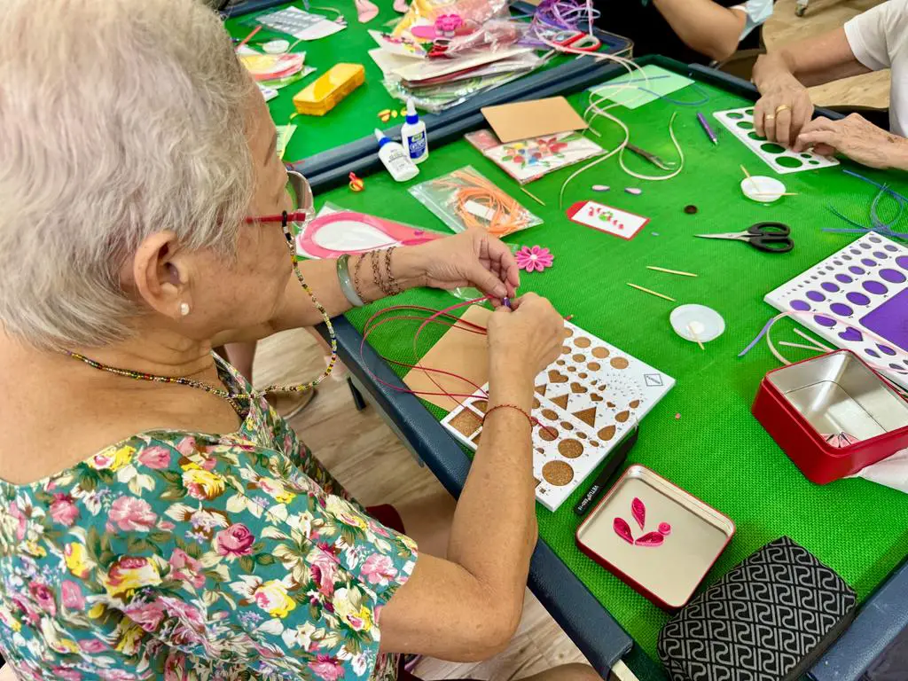 elderly lady doing paper quilling in aged care