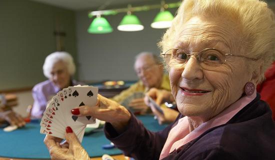 Senior lady playing casino card game