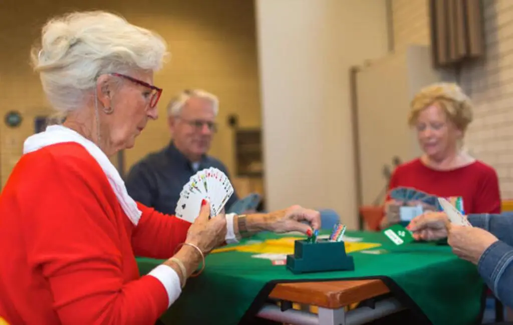 elderly lady playing card game in aged care