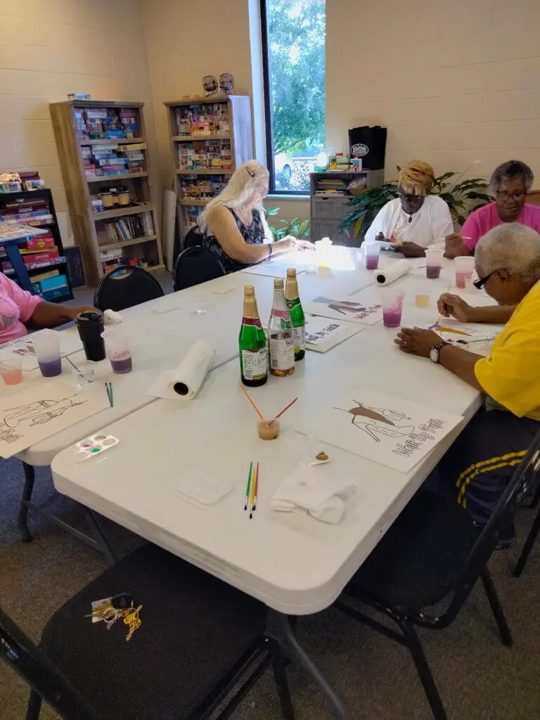 Group of seniors doing sip and paint
