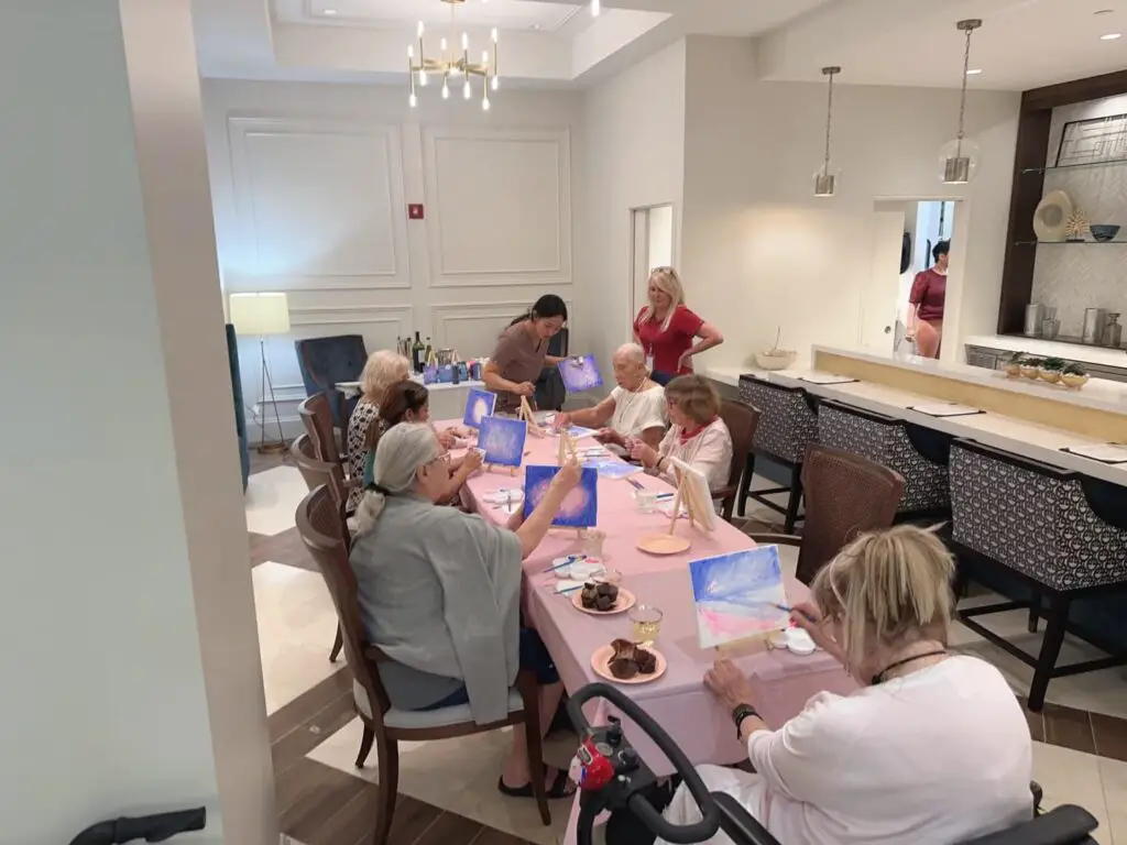 group of seniors painting in aged care 