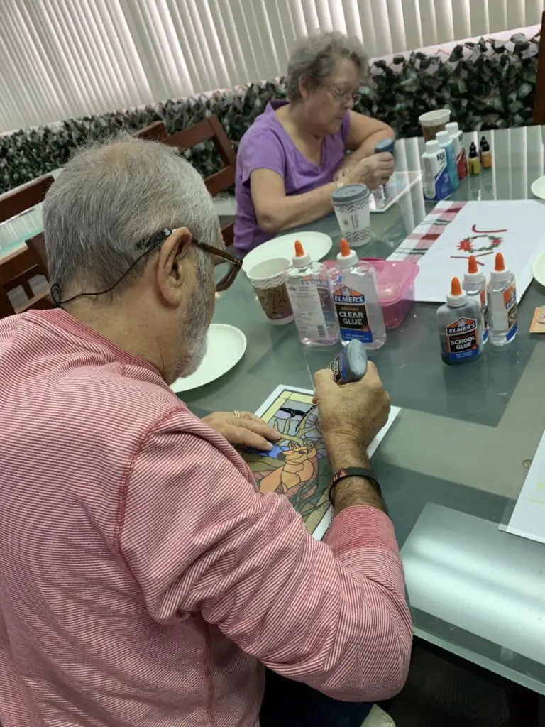 seniors in aged care doing Faux Stained Glass Activity