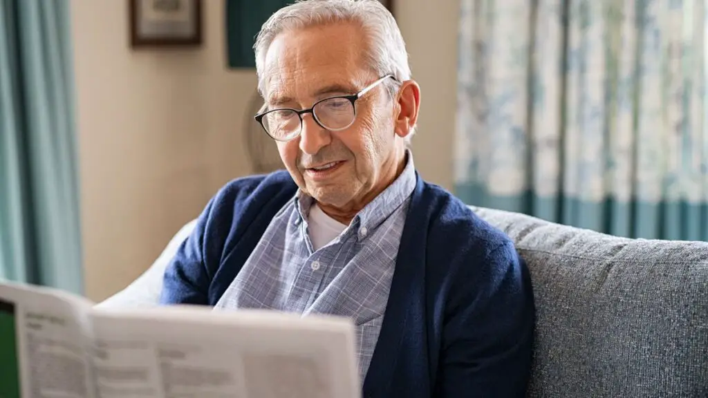 Elder reading newspaper