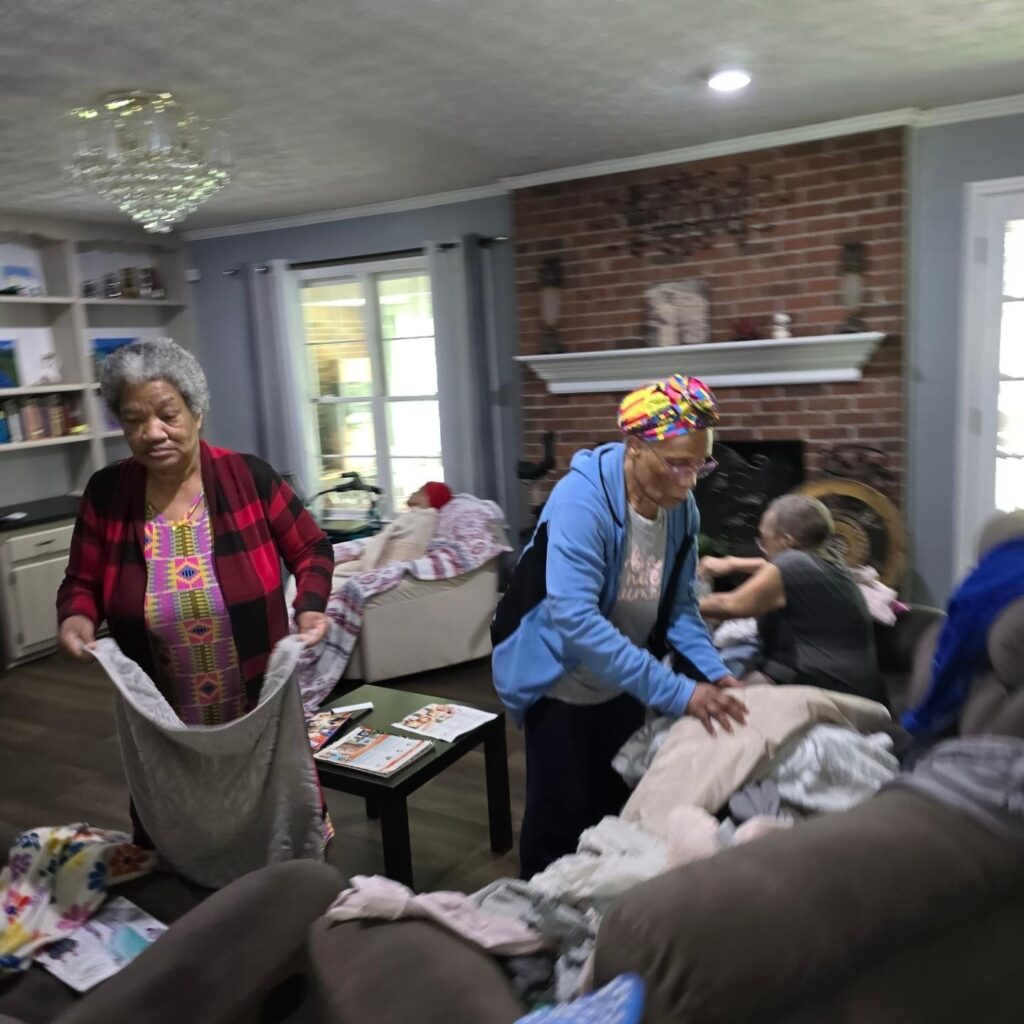 elderly women folding unfold clothes