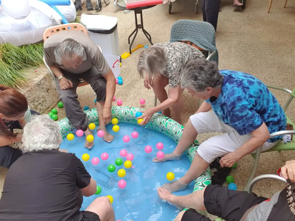 Seniors dipping feet in pool