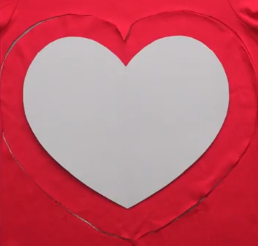 Cutting the shirt using the heart-shaped outline