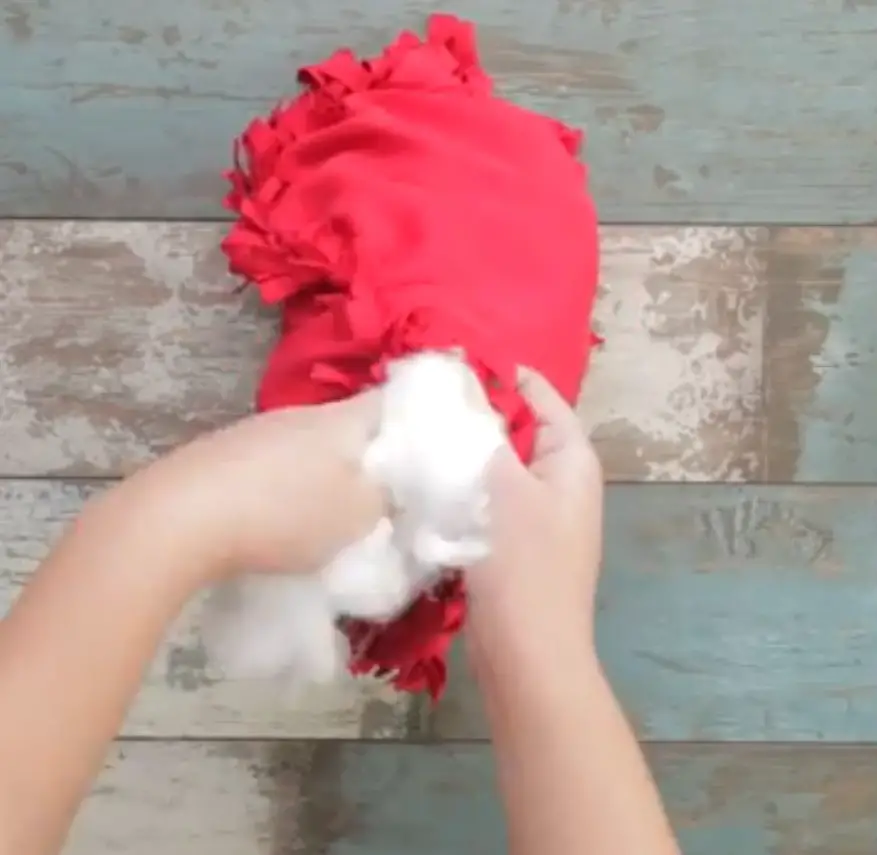 Stuffing the almost-done heart shaped pillow