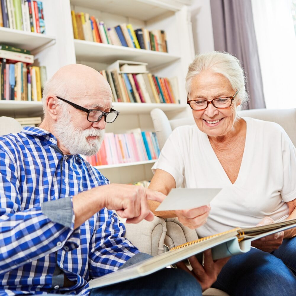 Two seniors reminiscing over an old photo